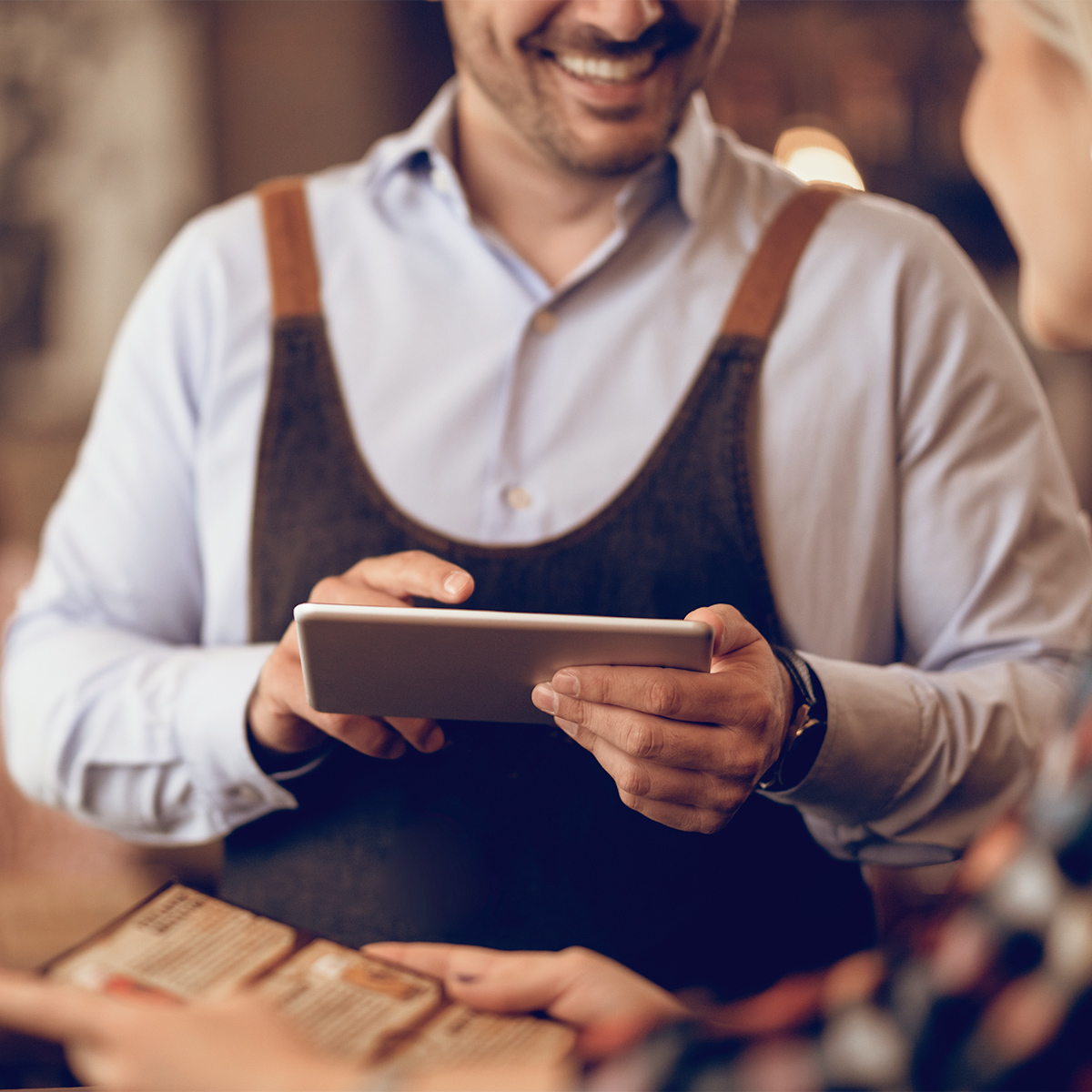 Waiter taking customers' order
